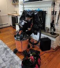 Indoor fireplace service setup with a vacuum and cleaning tools